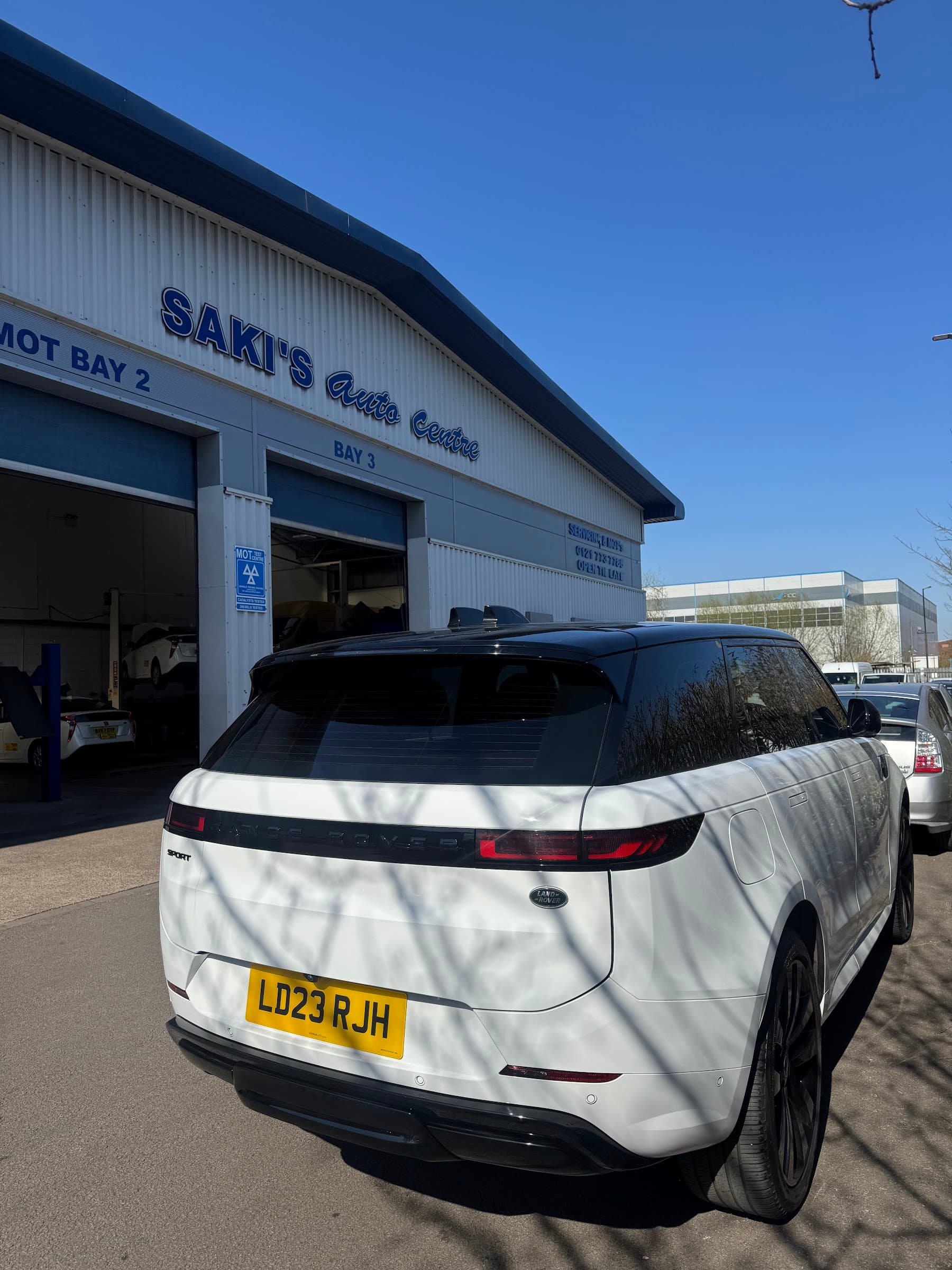 Saki's Auto Centre exterior with MOT bay signage and workshop doors
