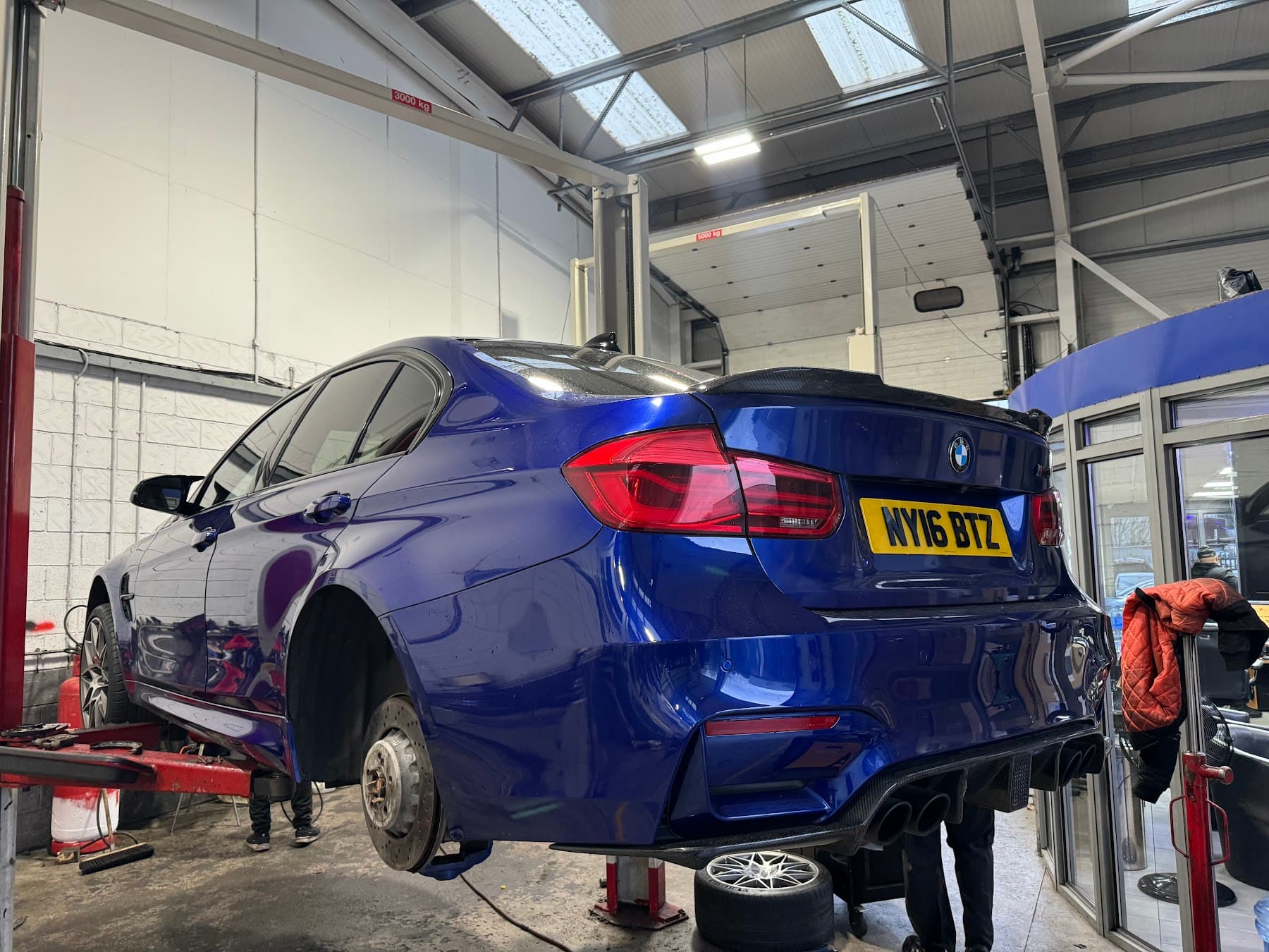 BMW in Saki's Auto Centre workshop with wheel removed