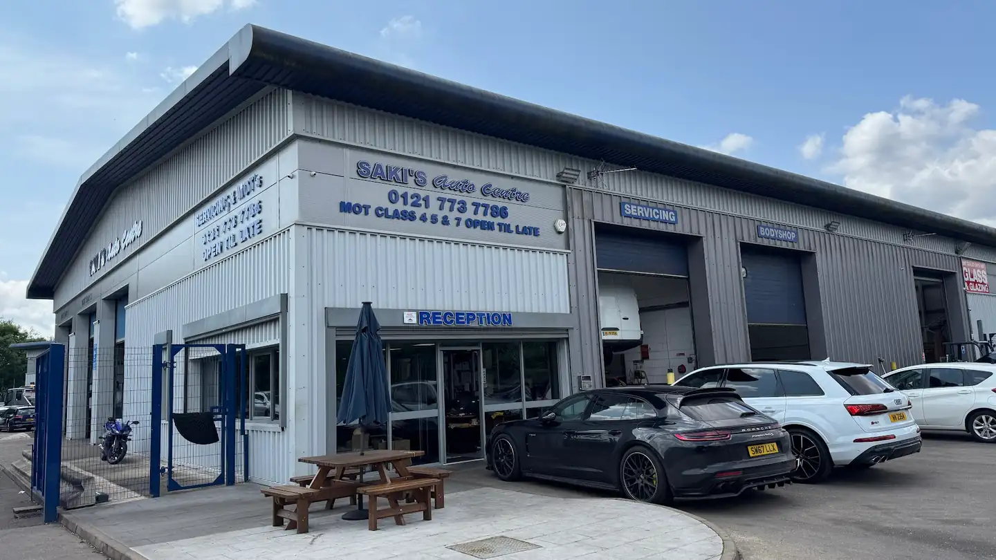 Saki's Auto Centre frontage with reception, servicing and bodyshop signs